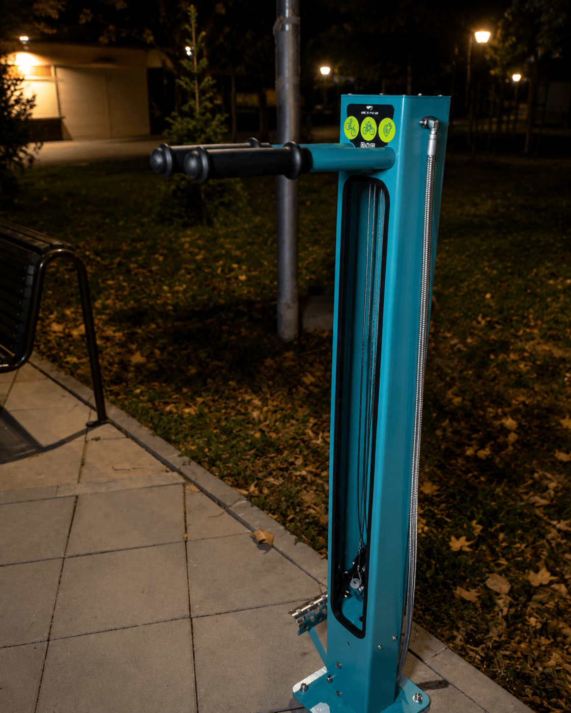 Custom outdoor bicycle repair station in a public park at night